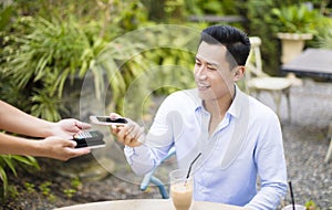 Man paying bill through smartphone