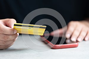 Man paying with a credit card online while making orders via the Internet