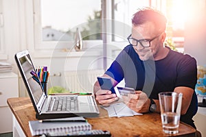 Man paying with credit card on smart phone