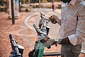 Man is paying for electro scooter using his mobile phone