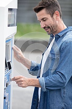 man paying for gasoline in gas station pump