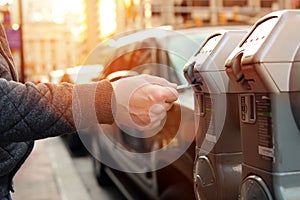 Man is paying his parking using credit card at parking pay station terminal