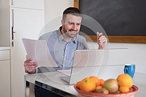 Man paying invoices using internet online service