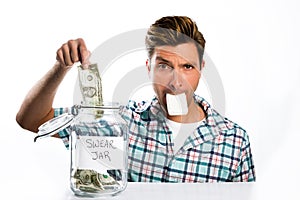 Man paying a swear jar