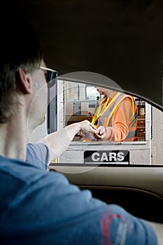 Man paying toll at toll booth photo