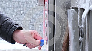 Man paying for Washing car on touchless car wash self-service. Winter cleaning in car wash. Cleanliness and order in