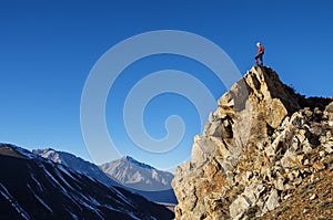 Man On Peak Looking At Mountains