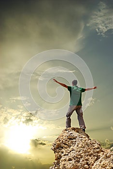 Man on peak of mountain