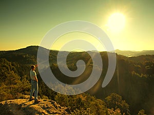 Man on the peak of sandstone rock in national park