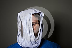 Man peeking out through the hole in the underwear on his head