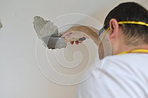 Man Peeling a Ceiling