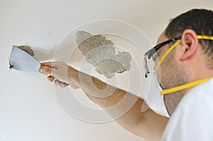 Man Peeling a Ceiling
