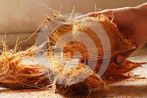 man peeling coconut