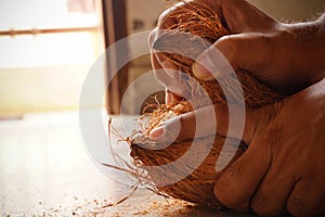 man peeling coconut
