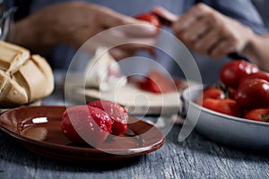 Man peeling scalded tomatoes