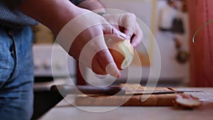 Man Peels The Onions at home kitchen