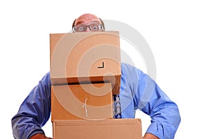 Man peeps over heavy boxes while carrying them
