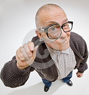 Man peering through magnifying glass photo