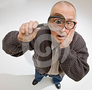 Man peering through magnifying glass