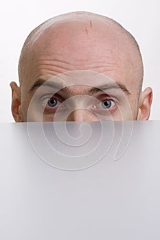 Man peering over a cubicle photo