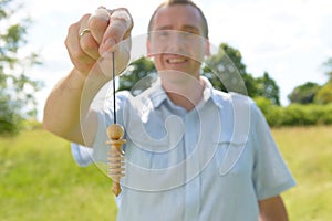 Man with pendulum