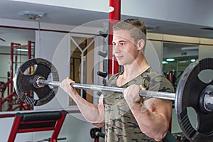 Man performing barbell curl at the gym