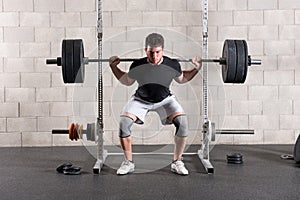 Man performing a crossfit back squat exercise photo