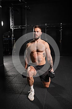 Man performing dumbbell lunge, holding dumbells in both hands. Routine workout for physical and mental health.