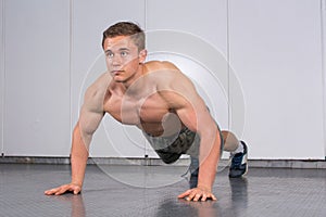 Man performing push ups at the gym