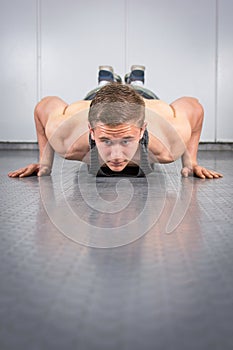 Man performing push ups at the gym