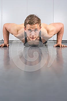 Man performing push ups at the gym