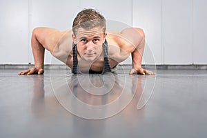 Man performing push ups at the gym