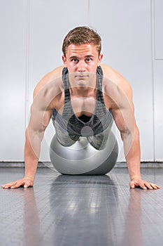 Man performing push ups at the gym