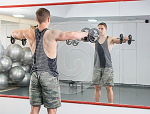 Man performing shoulder workout at the gym