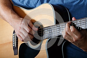 Man performing song on acoustic guitar