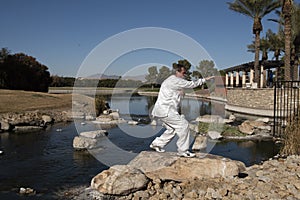 Man Performing Tai Chi on rock