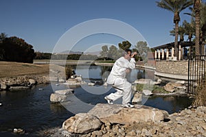 Man Performing Tai Chi on rock