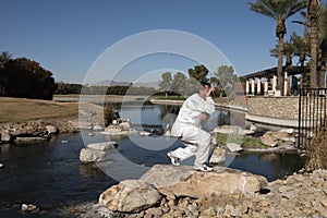 Man Performing Tai Chi on rock