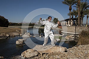 Man Performing Tai Chi on rock