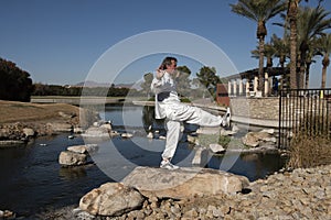 Man Performing Tai Chi on rock