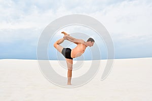 Man performing a yoga pose natarajasana