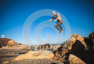 Man performs freerunning jump on stones