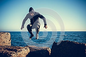 Man performs freerunning jump on stones