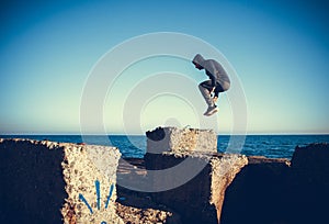 Man performs freerunning jump on stones