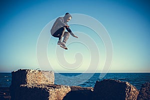 Man performs freerunning jump on stones