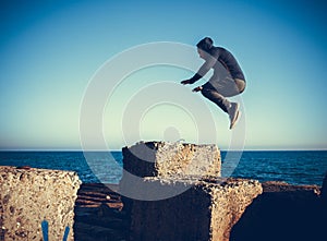 Man performs freerunning jump on stones