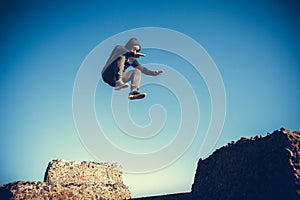 Man performs freerunning jump on stones