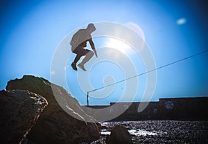 Man performs freerunning jump on stones