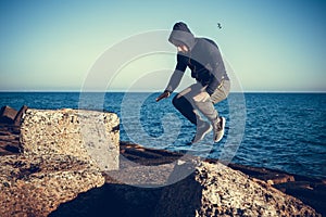 Man performs freerunning jump on stones