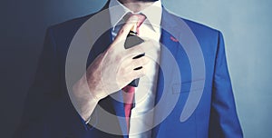 Man is perfuming himself